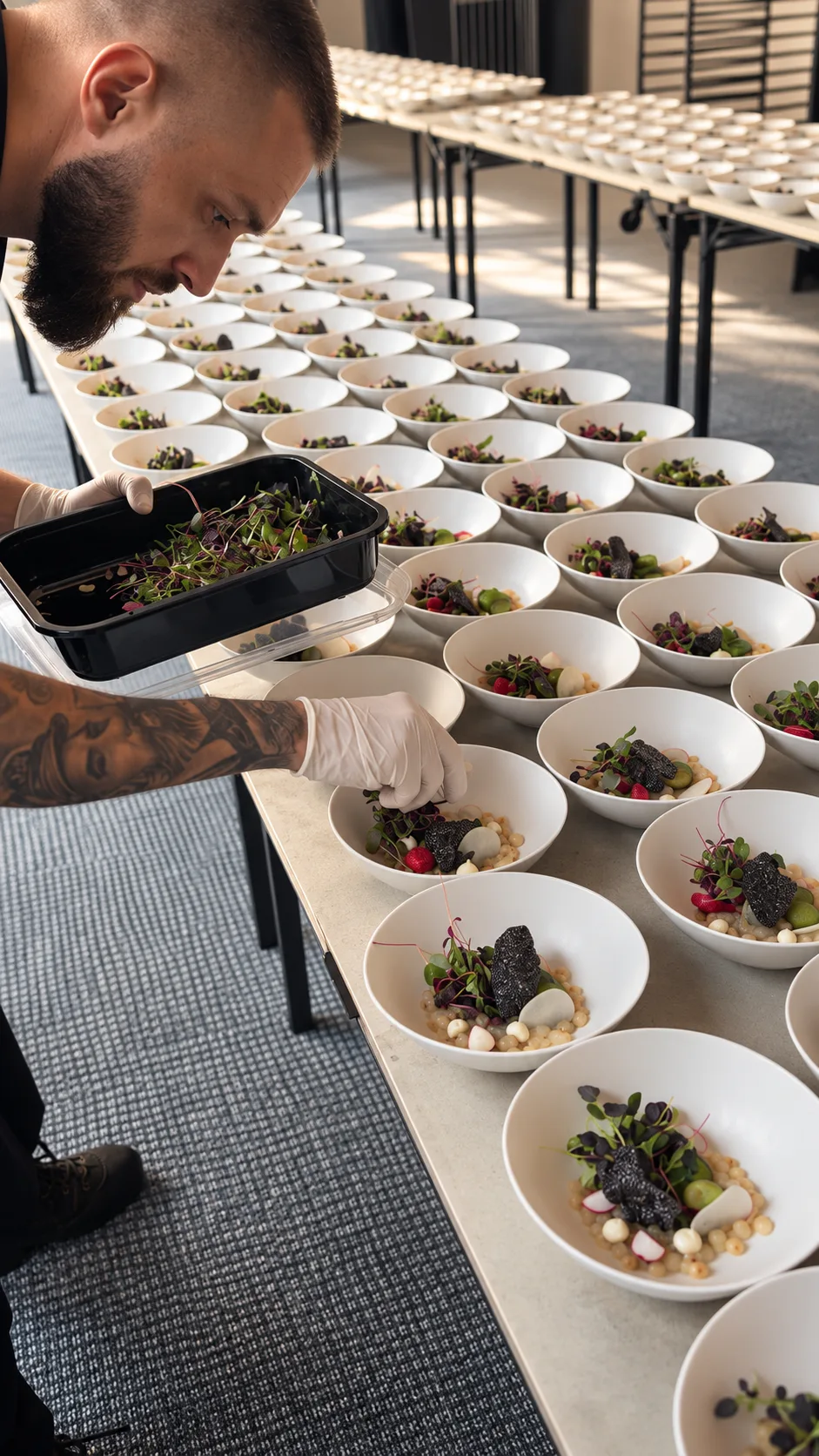 Chef Petre plating dishes for a large event