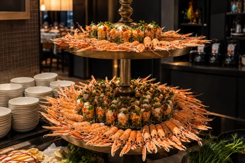 A tiered display of prepared food for an event