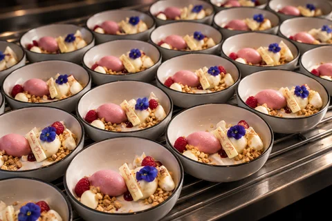 Rows of desserts garnished with flowers